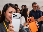 iPhone 17 Pro Max Buying Guide in Nigeria: Storage and Features Lady holding two iPhone 17 Pro Max smartphones showcasing premium design and dual color options