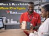 Where to Buy a Reliable iPhone XS in Nigeria? Kara.com.ng store staff showing iPhone XS phones to a customer inside a smartphone retail shop in Nigeria.