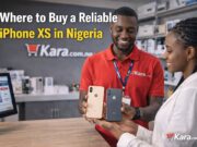 Where to Buy a Reliable iPhone XS in Nigeria? Kara.com.ng store staff showing iPhone XS phones to a customer inside a smartphone retail shop in Nigeria.