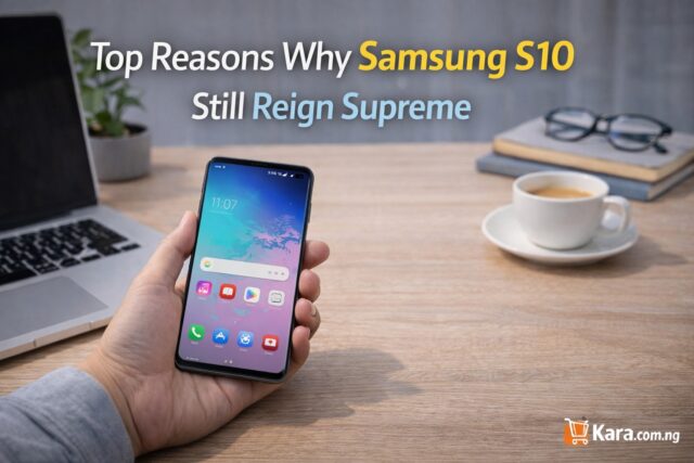 Person holding a Samsung Galaxy S10 smartphone on a modern desk workspace with laptop and coffee cup while highlighting why the phone remains popular.